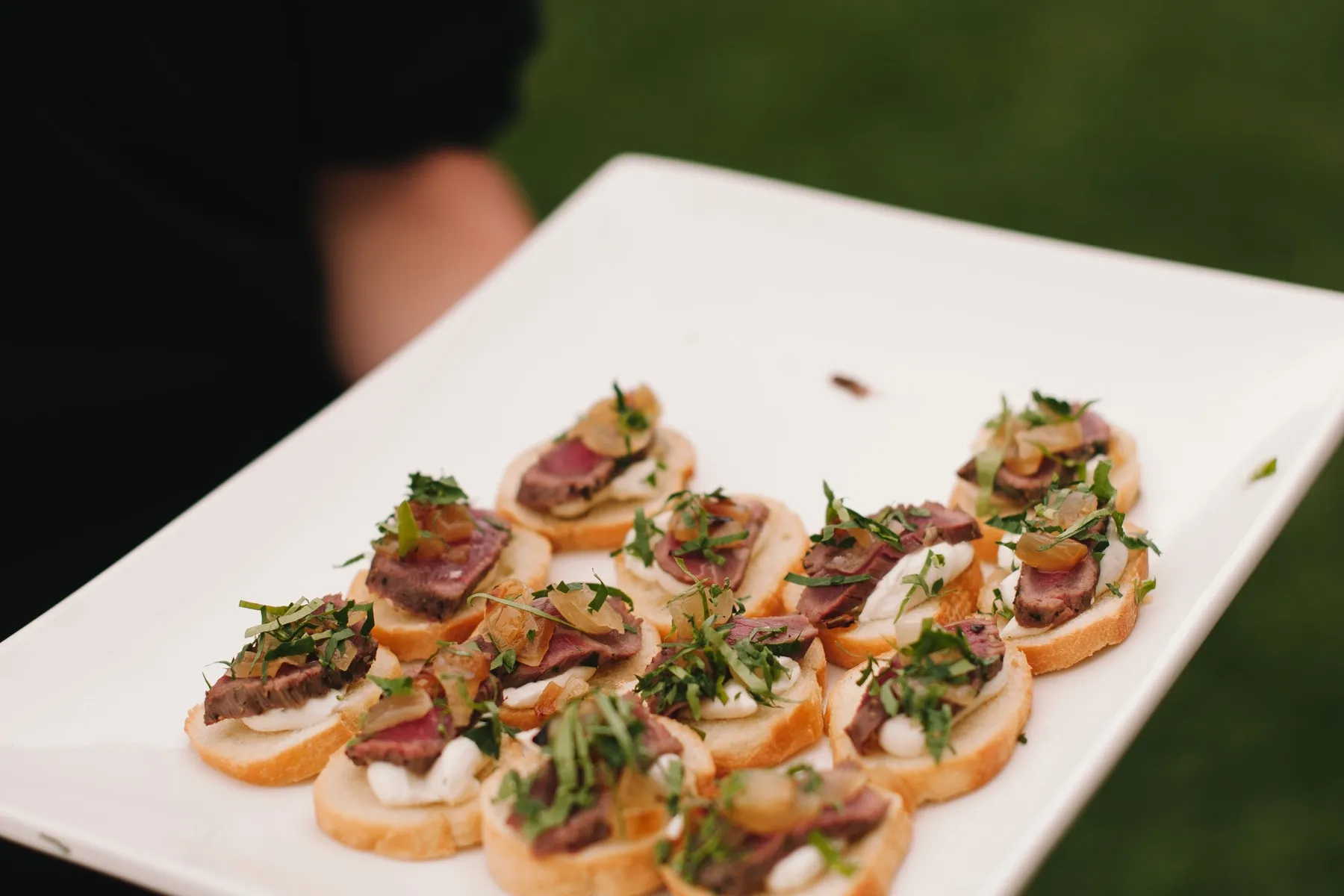 Beef canapes with microgreens on a passed tray