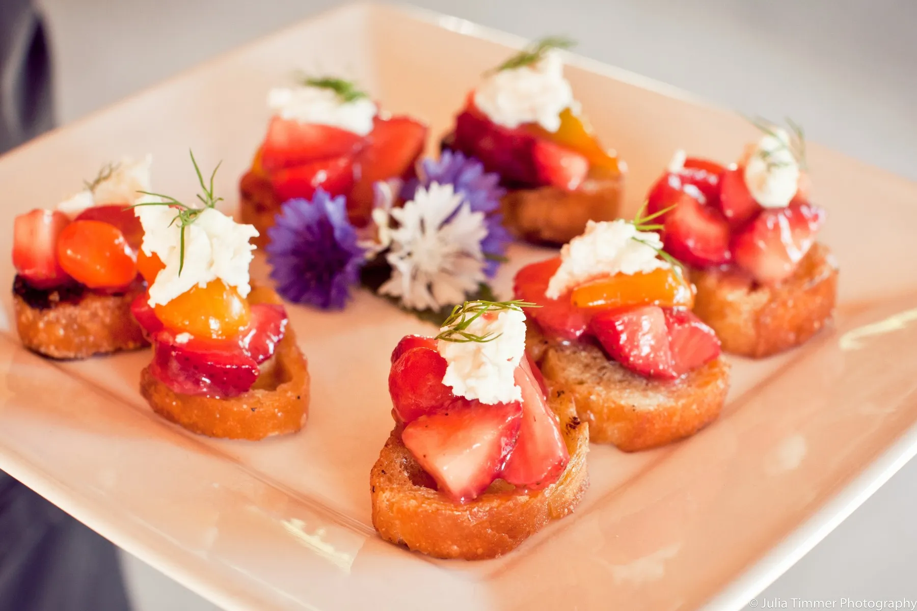Strawberry and whipped ricotta crostini on a platter